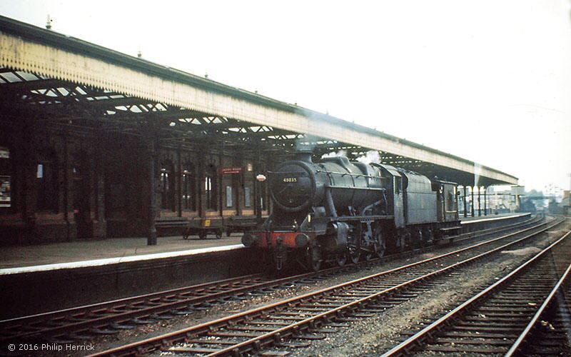8F 2-8-0 no. 48035 passes through Leicester Central station with a break van in June 1966